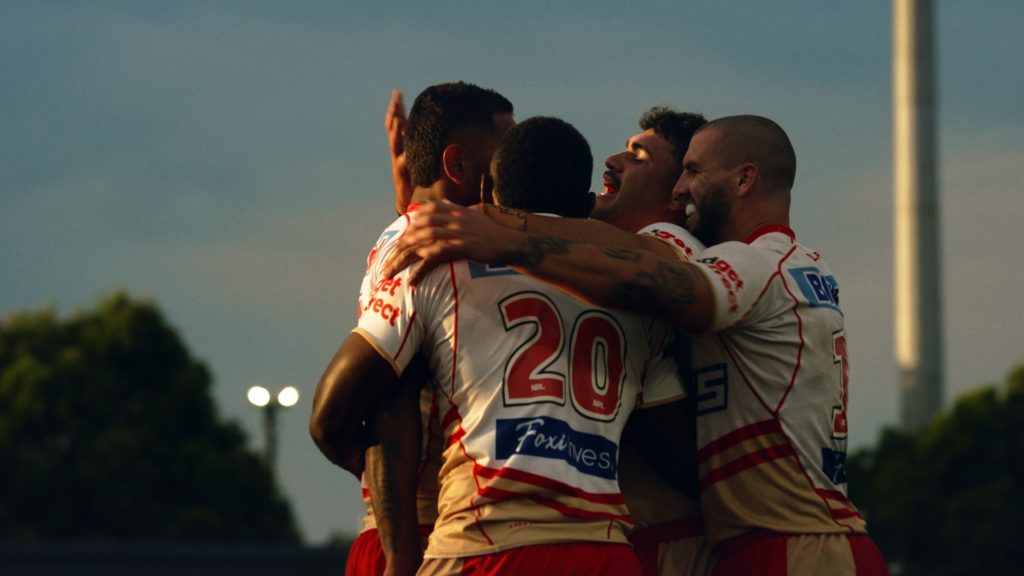 Peachy Senior Colourist Angela Cerasi's warm and natural colour grade of The Dolphins rugby team embracing after a victory, for the Stan Original series "Dawn of the Dolphins"