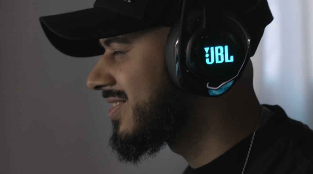 Image from Peachy's JBL case study featuring a man smiling with JBL headphones on