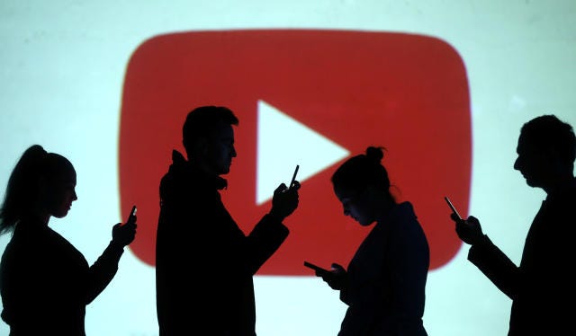 Image of people looking at their phones in front of a YouTube play logo, for the blog "YouTube and the Future of Broadcasting"