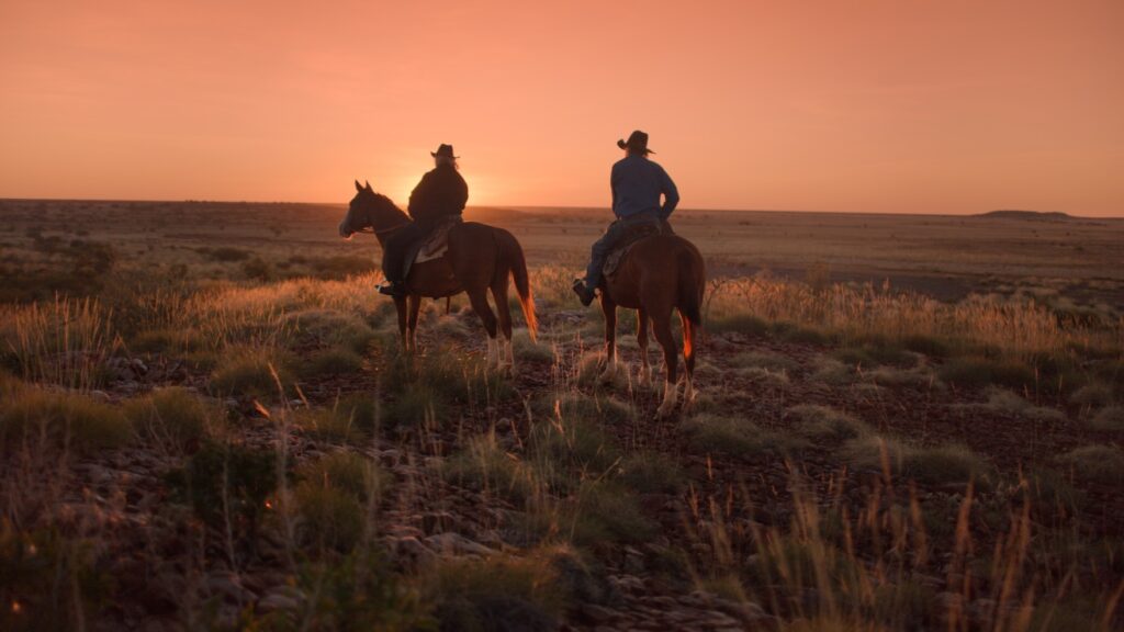 Australian Documentary Colour Grade image of Yurlu | Country, graded by Senior Colourist Angela Cerasi, image of two people on horseback at sunset