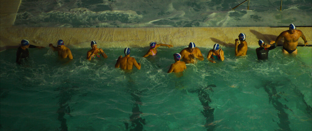 Colour Graded image of swimmers in churning water for the documentary The Pool